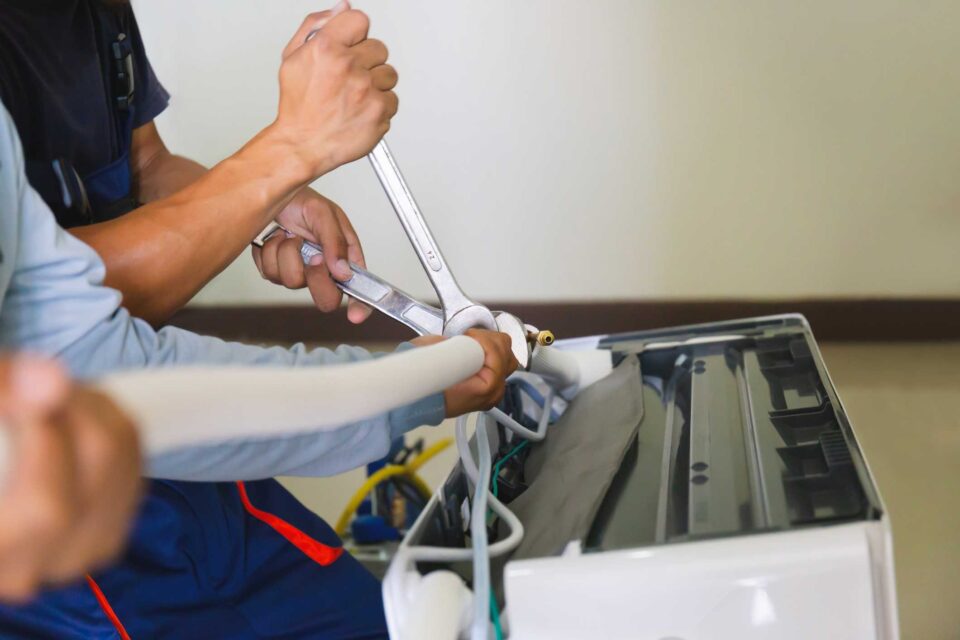 Technician repairing ductless mini-split AC in Lawrenceville, GA