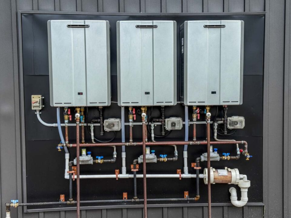 High‑efficiency tankless water heater units with connected piping in Duluth, GA