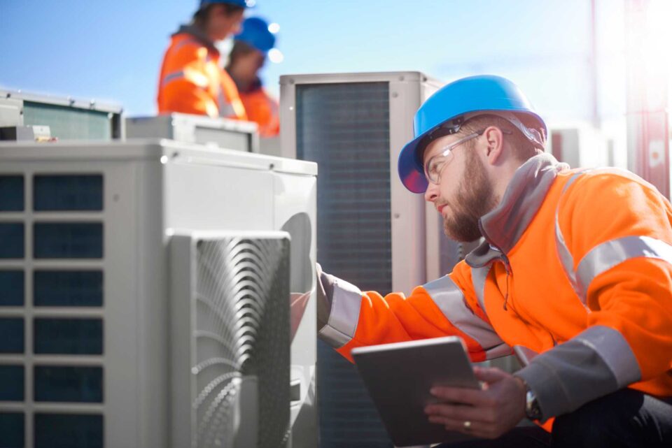 HVAC technician performing commercial air conditioning maintenance in North Atlanta Metro