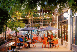 HVAC services in Duluth, GA, vibrant restaurant interior with murals and tables, lively atmosphere.