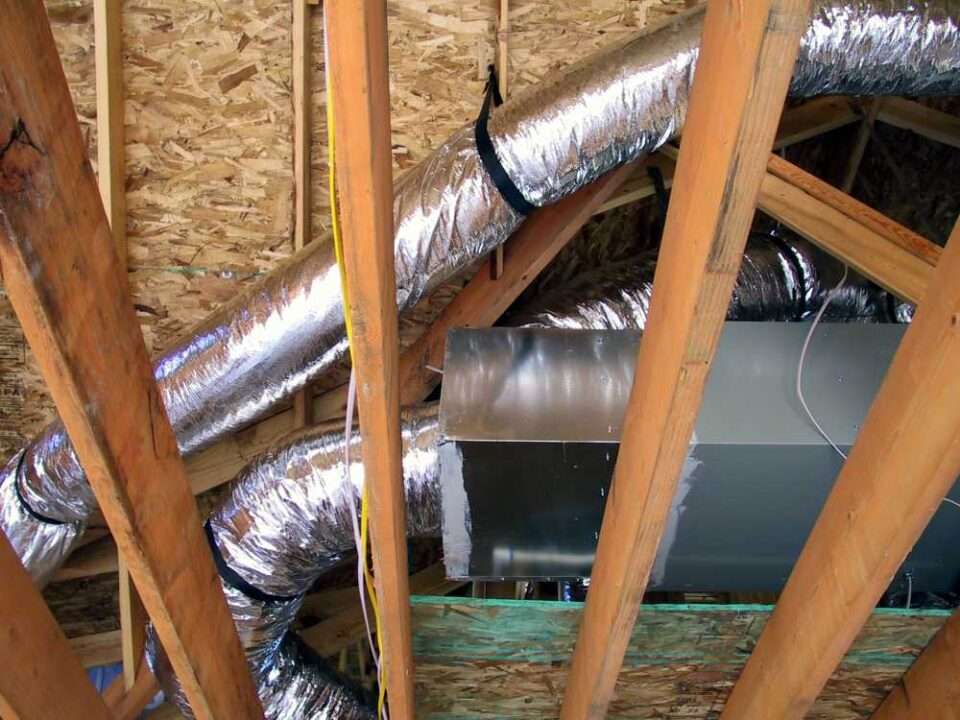 Close-up of a metal duct surrounded by insulation, showing HVAC installation in North Atlanta Metro.